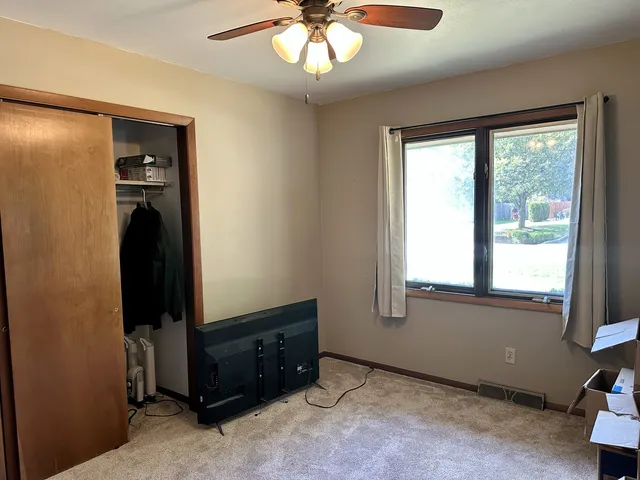 a bathroom with a granite countertop toilet sink and mirror