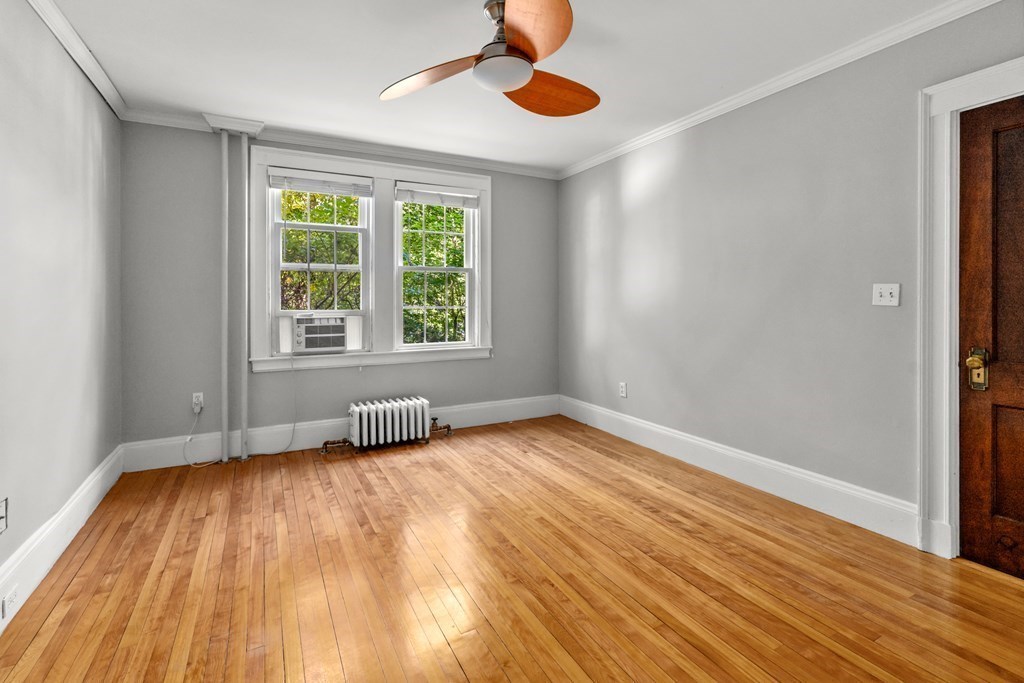 34 Weston Road Wellesley, MA 02482 - Photo 15 of 19 a view of an empty room with wooden floor and a window