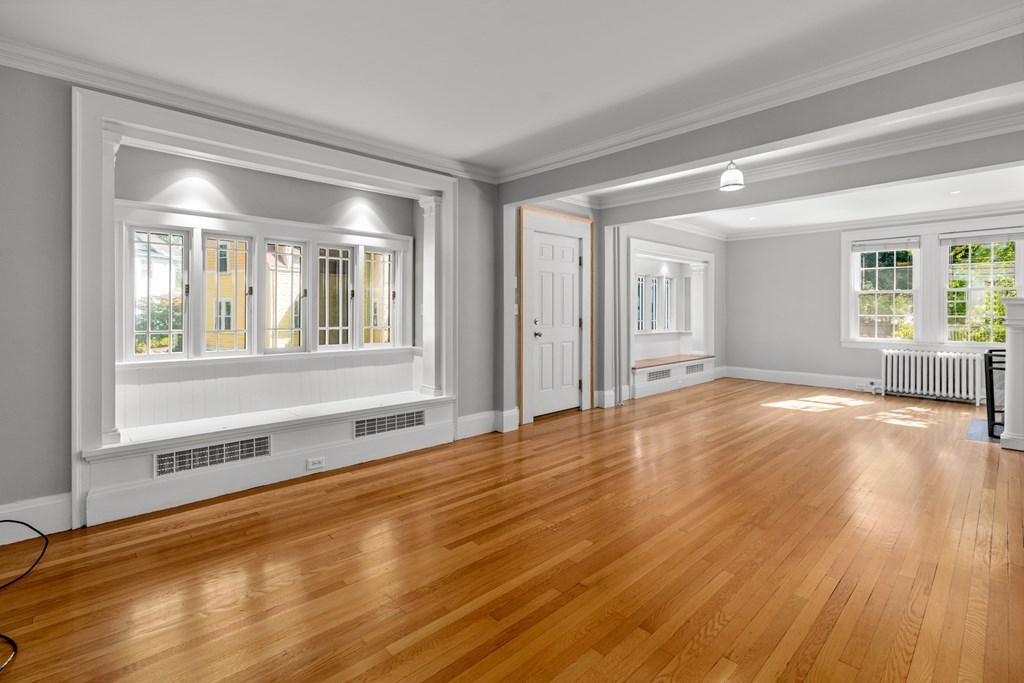 34 Weston Road Wellesley, MA 02482 - Photo 8 of 19 a view of an empty room with wooden floor and a window