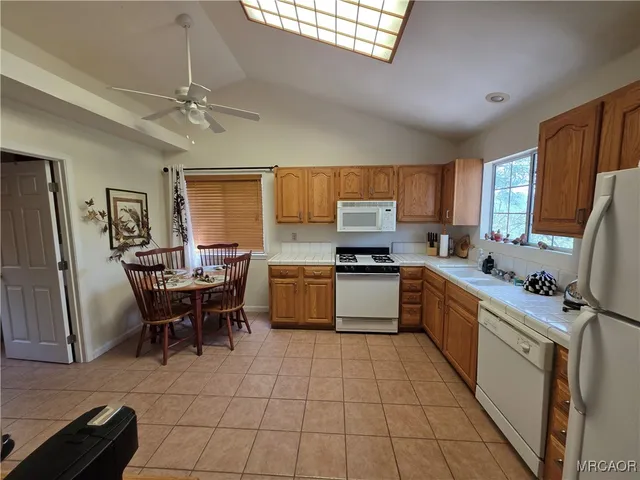 a kitchen with a sink appliances and cabinets