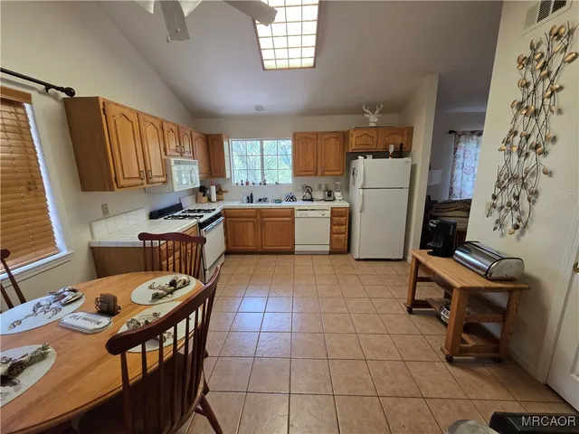 a kitchen with a sink a stove a refrigerator and furniture