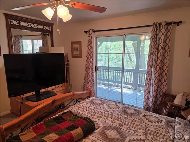 a bedroom with a bed and flat screen tv