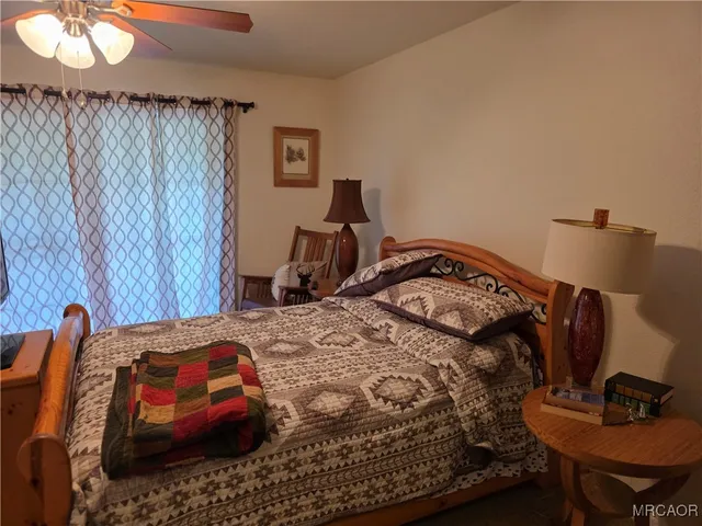 a bedroom with a bed and a chair