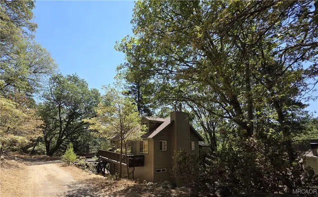 a yellow house with trees in front of it