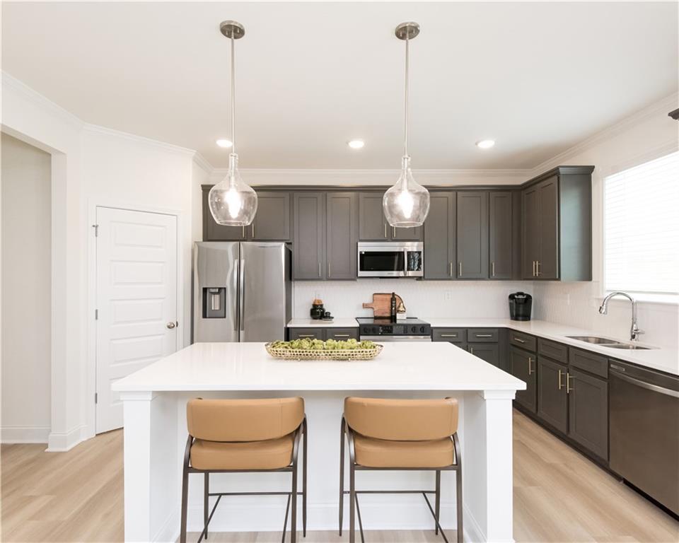 5910 Springs Way Stonecrest, GA 30038 - Photo 19 of 35 a kitchen with a sink cabinets and window