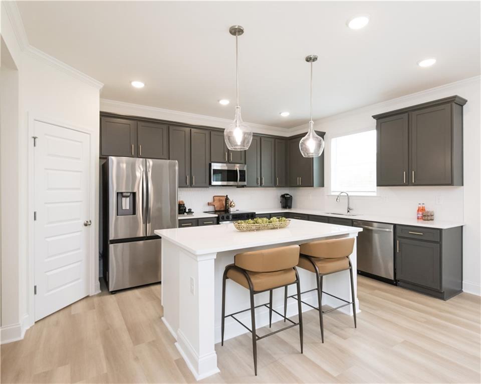 5910 Springs Way Stonecrest, GA 30038 - Photo 20 of 35 a kitchen with refrigerator a sink and chairs