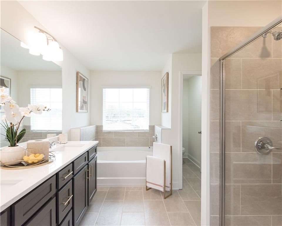 5910 Springs Way Stonecrest, GA 30038 - Photo 28 of 35 a bathroom with a tub sink and mirror