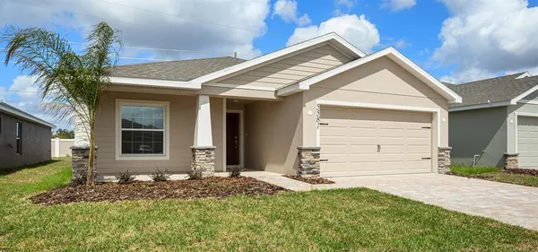 a view of house with backyard and parking space