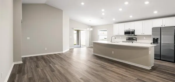 a kitchen with stainless steel appliances a refrigerator sink and microwave
