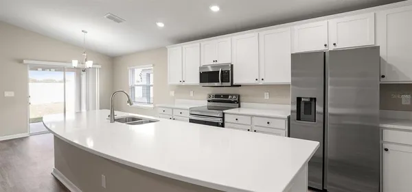 a kitchen with stainless steel appliances a refrigerator stove microwave and cabinets