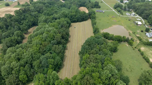 an aerial view of a house with pool and garden