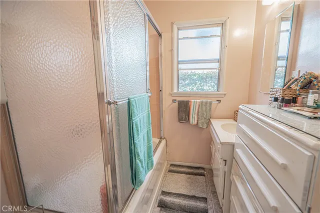 a view of a bedroom with wooden floor and a window