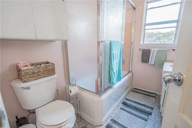 a bathroom with a toilet a sink and a window