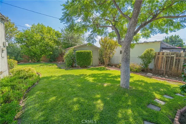 a view of a garden with a house