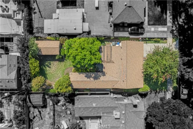 an aerial view of a house with garden space and street view