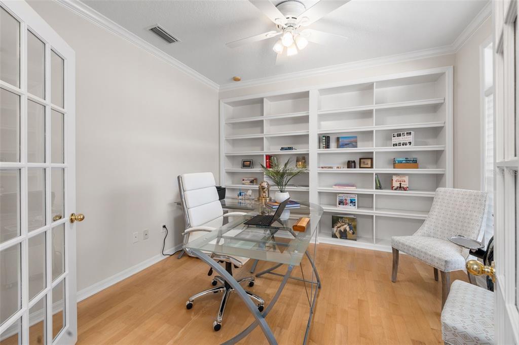 7418 White Oaks Road Alachua, FL 32615 - Photo 5 of 46 a view of a workspace with furniture and a bookshelf