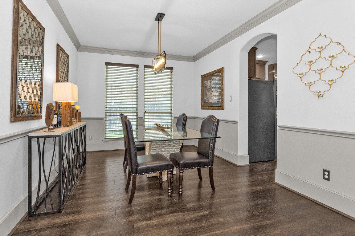 106 Cliftons Curve Way Montgomery, TX 77316 - Photo 14 of 47 The formal dining room showcases rich wood floors with a graceful archway leading to the kitchen—creating a seamless flow that makes entertaining both effortless and elegant.
