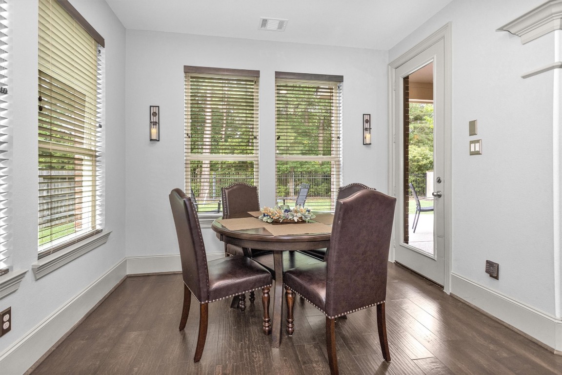 106 Cliftons Curve Way Montgomery, TX 77316 - Photo 21 of 47 Bright breakfast area with large windows, wooden floors, and direct access to a patio. Perfect for casual meals and entertaining.