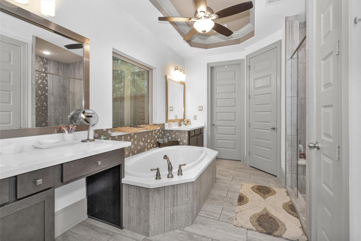106 Cliftons Curve Way Montgomery, TX 77316 - Photo 26 of 47 This bathroom features a luxurious soaking tub, dual vanities w/ample counter space, a large walk-in shower, custom painted doors, and elegant flooring.