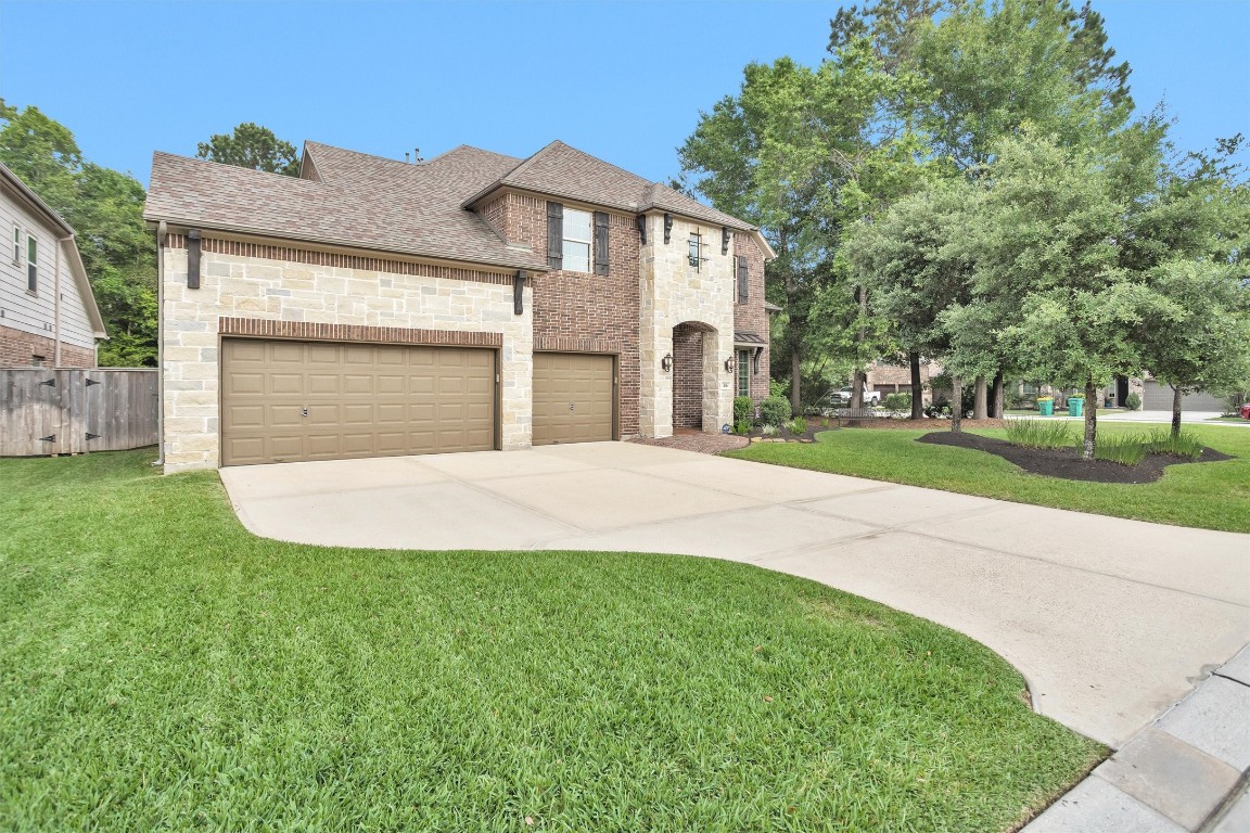 106 Cliftons Curve Way Montgomery, TX 77316 - Photo 4 of 47 Rare Find! Extended driveway creates a grand approach, offering ample space for parking while enhancing the home’s curb appeal.