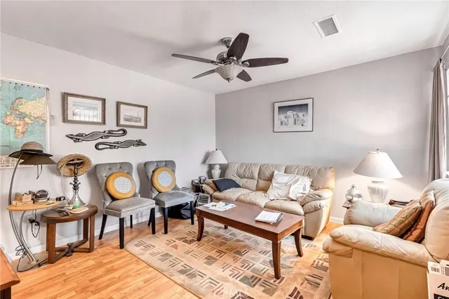 a living room with furniture and painting on the wall