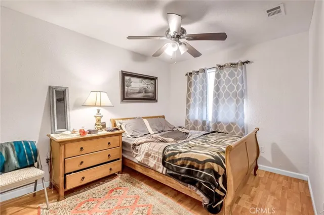 a bedroom with furniture and a mirror