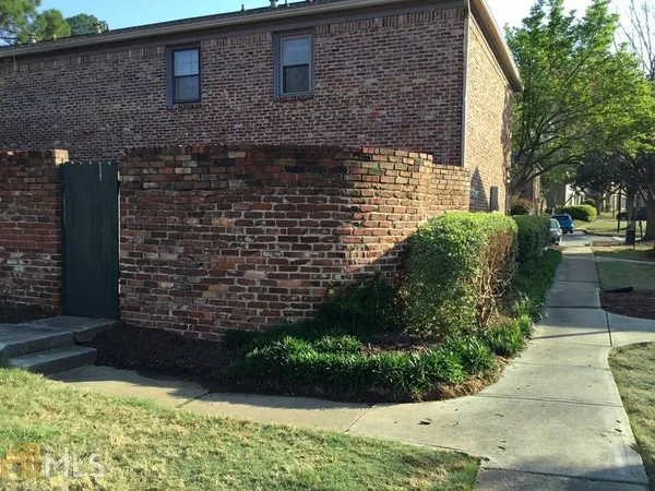 a brick building with a yard