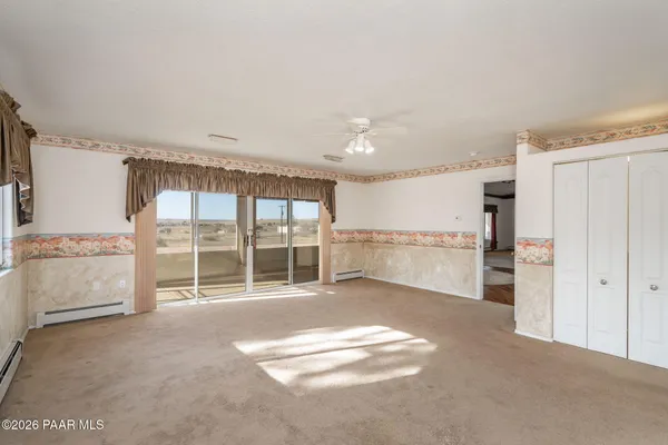 a view of house with backyard and glass windows