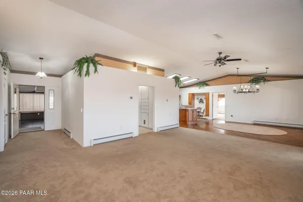 a spacious bathroom with a granite countertop sink a toilet and a mirror