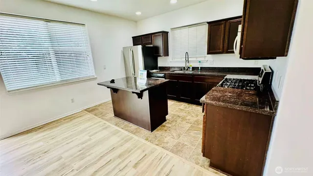 a kitchen with a sink stove and refrigerator