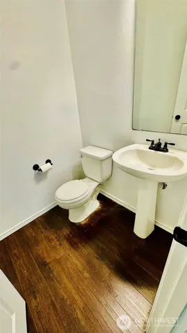 a bathroom with a sink toilet and mirror