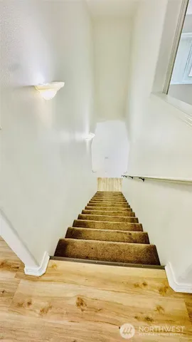 a bedroom with a rug and wooden floor