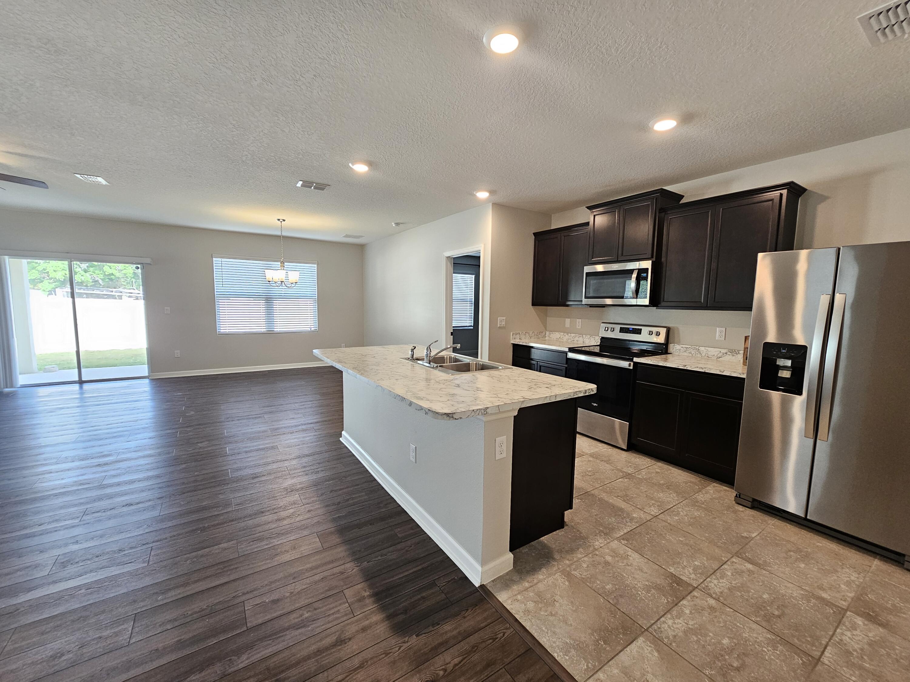 480 Sorrento Drive Cocoa, FL 32922 - Photo 7 of 24 a large kitchen with stainless steel appliances granite countertop a large counter top a sink a refrigerator and a stove