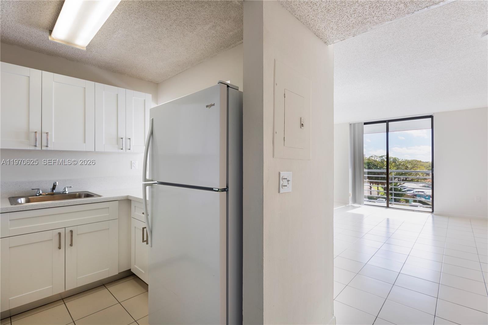 a white refrigerator freezer sitting inside of a kitchen