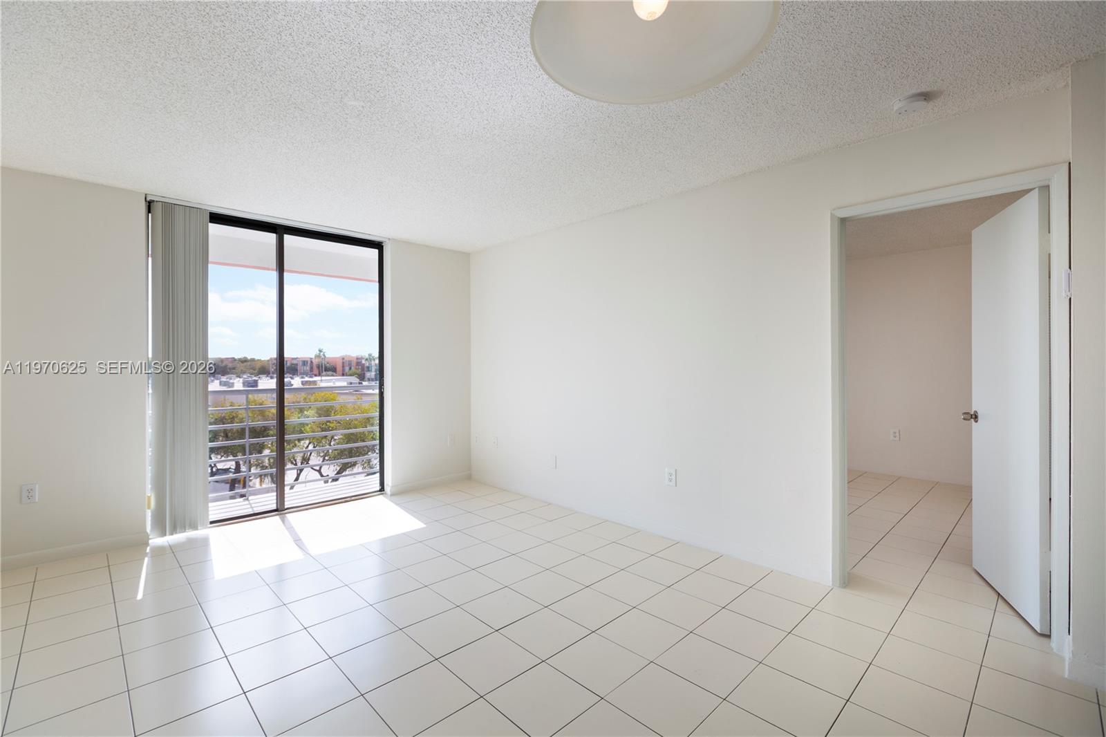 191 Northwest 97th Avenue, Unit 421 Miami, FL 33174 - Photo 5 of 15 a view of an empty room and window