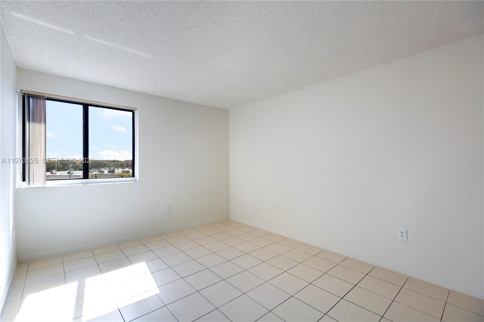 191 Northwest 97th Avenue, Unit 421 Miami, FL 33174 - Photo 6 of 15 an empty room with windows