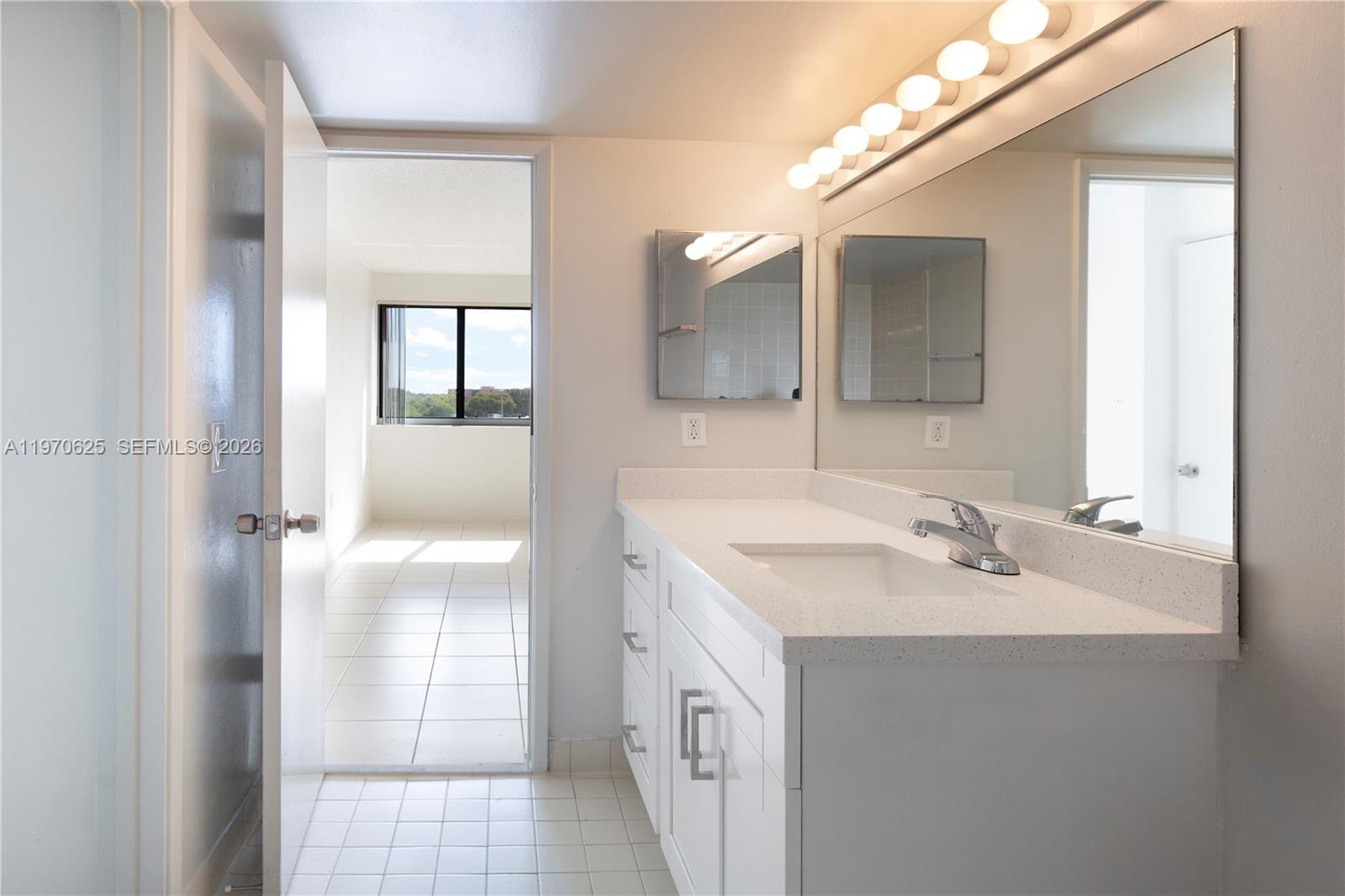 191 Northwest 97th Avenue, Unit 421 Miami, FL 33174 - Photo 10 of 15 a spacious bathroom with a double vanity sink mirror and