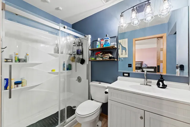 a bathroom with a sink a toilet and a mirror