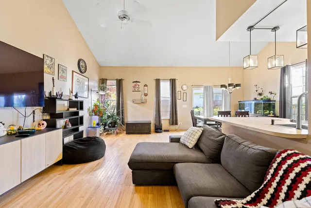 a living room with furniture fireplace and a large window