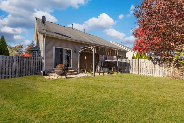 a view of a house with backyard porch and sitting area