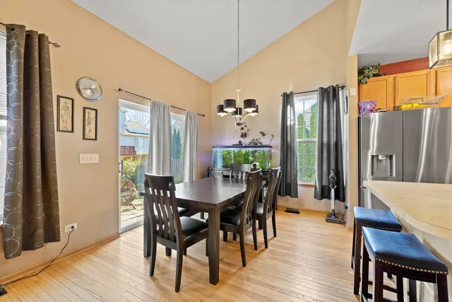 a view of a a dining room with furniture window and wooden floor