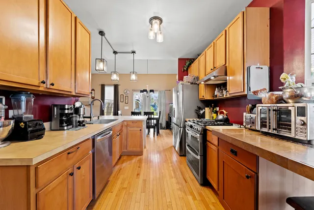 a kitchen with lots of counter top space and wooden floor