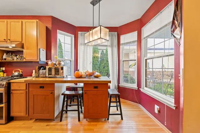 a dining table with chairs and window