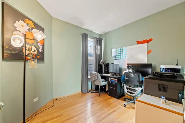 a view of a workspace with furniture and a window