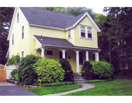 157 Weston Road Wellesley, MA 02482 - Photo 1 of 6 a view of a yard in front of a house with plants and large tree