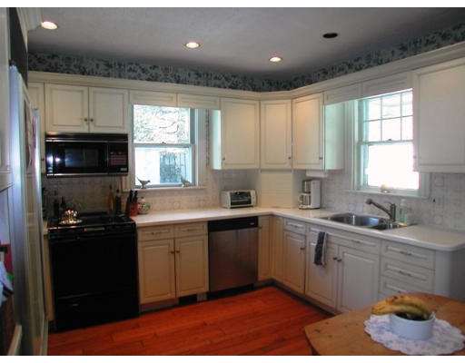157 Weston Road Wellesley, MA 02482 - Photo 3 of 6 a kitchen with a sink stove and cabinets