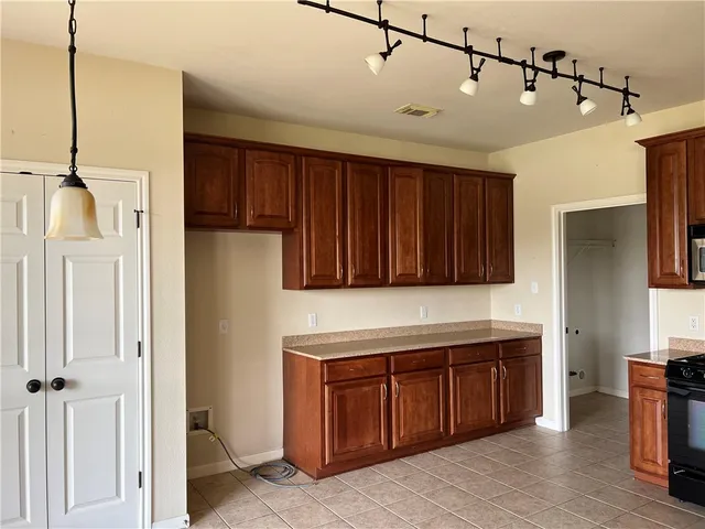 a kitchen with a refrigerator and a sink
