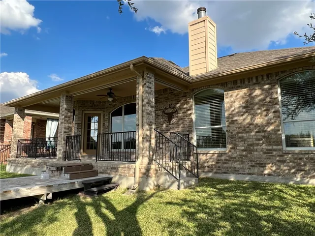 a view of house with swimming pool and porch