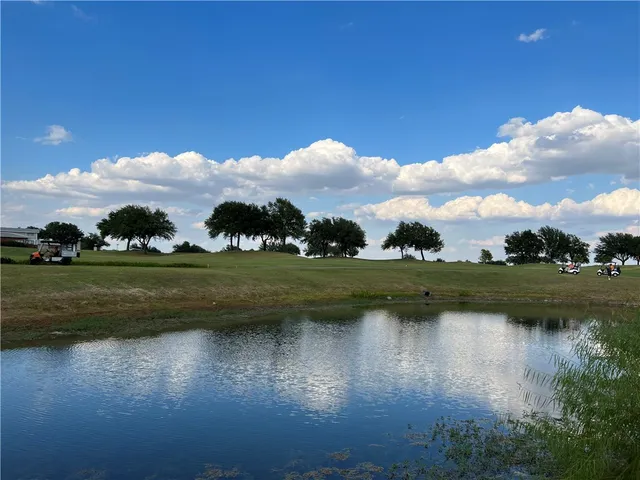 a view of a lake with houses in the background