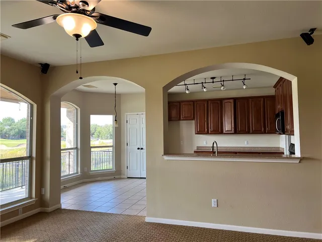 a view of a livingroom with a ceiling fan and window